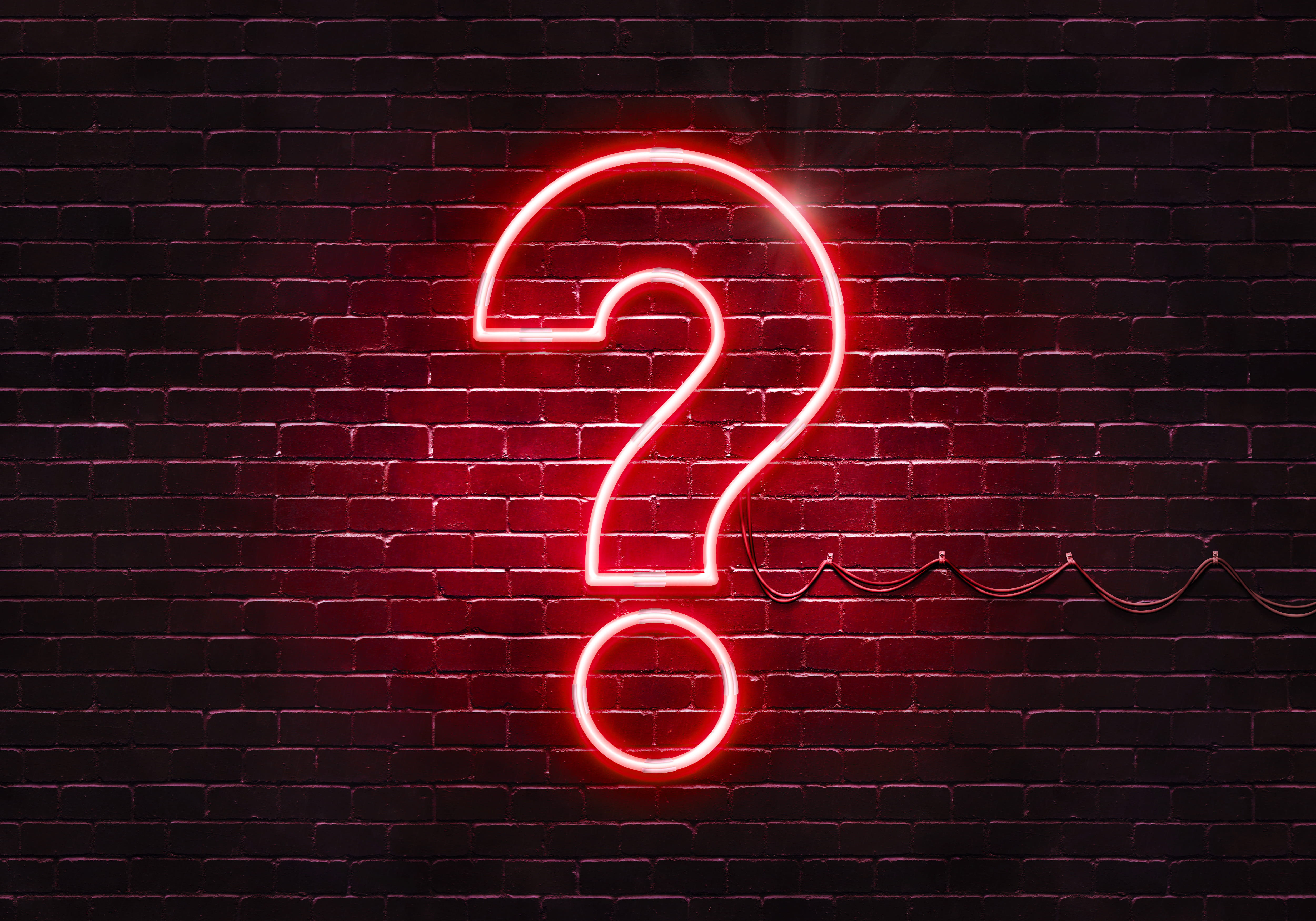 a question mark in the form of a neon light